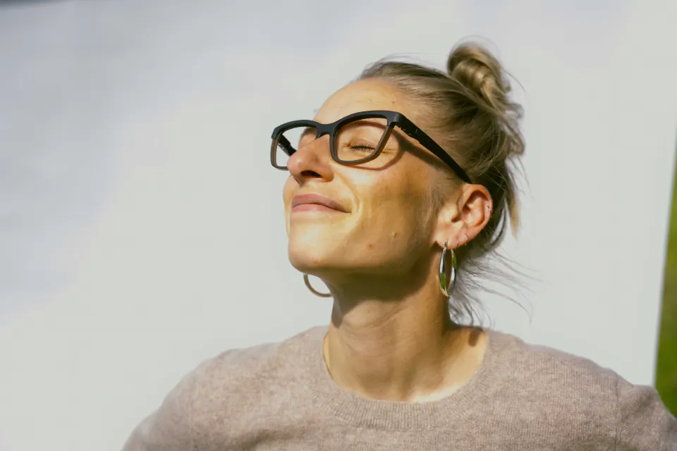 Monture Lars LACET portée par une femme, visage tourné vers le soleil
